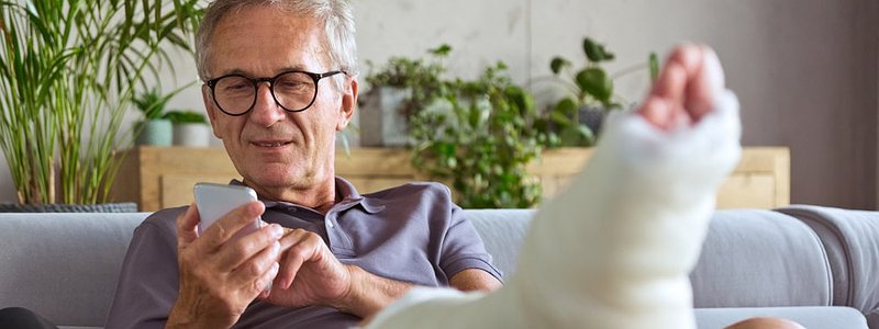 man-with-broken-leg-at-home